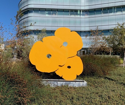 bright yellow sculpture depicting modern style poppies